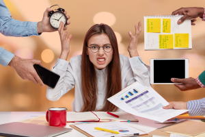 Overwhelmed manager at desk — visual metaphor for performance issues hidden behind busyness